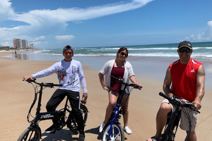 a group of people riding ebikes posing for the camera