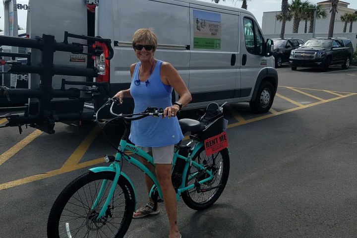 a woman on a baby blue ebike
