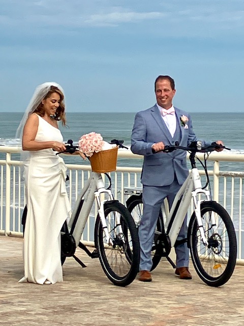 a couple of people riding on the back of a bicycle