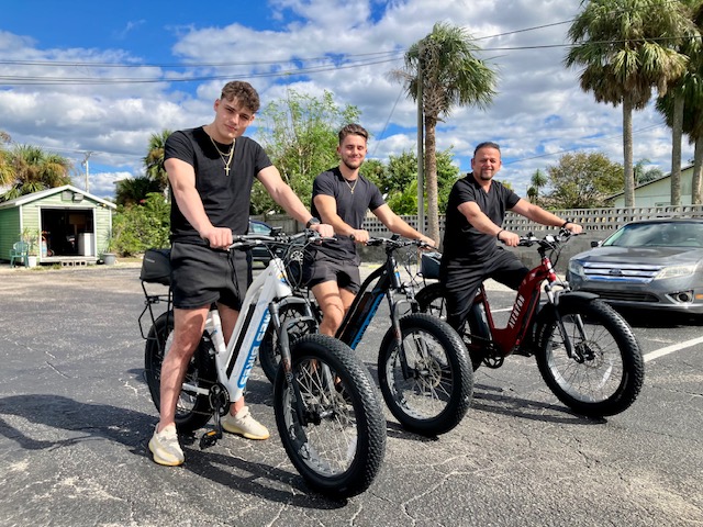 a group of people riding on the back of a motorcycle