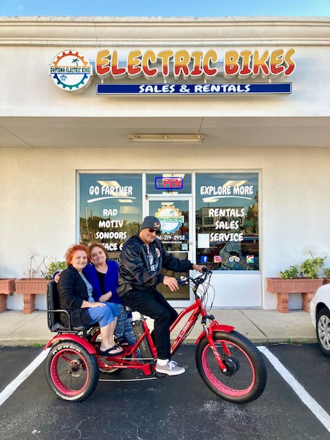 a man with a bicycle in front of a building